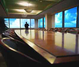 a large empty office conference room with a view of the sky